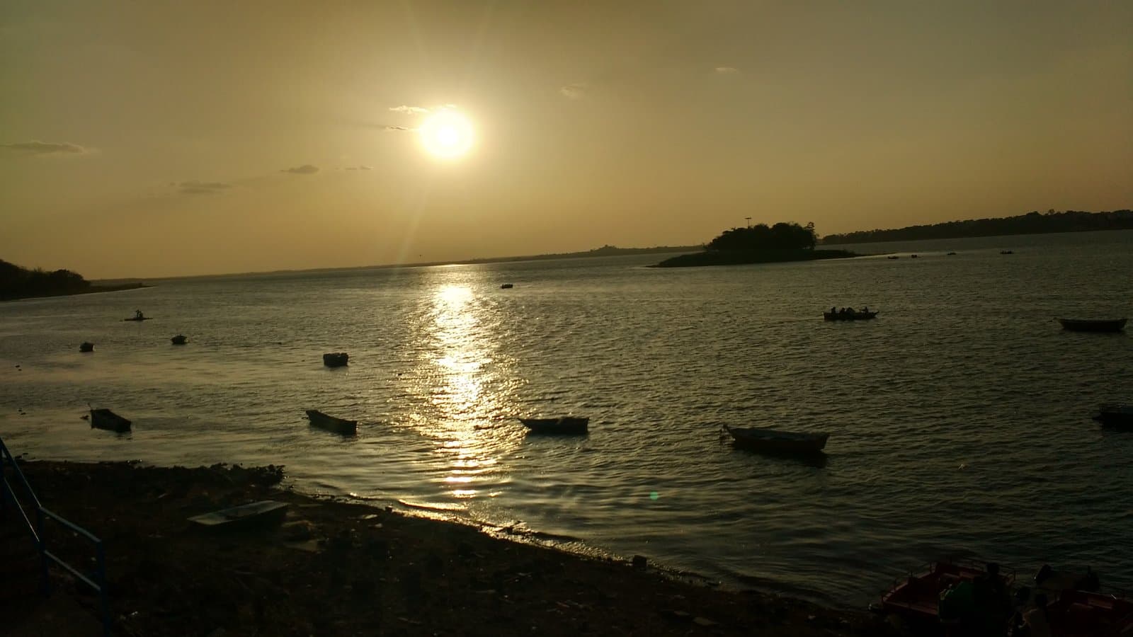 Sunset over Upper Lake Bhojtal in Bhopal with boats on the water